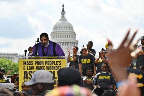 Rev. William Barber June 29 Rev. Barber speaks at lectern, Capitol building in background