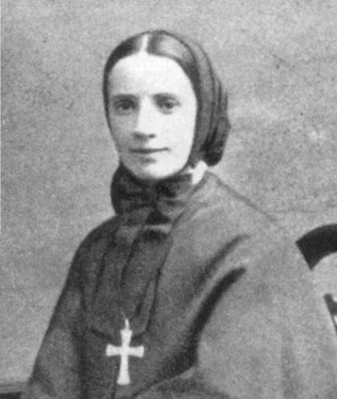 Francesca Cabrini. Black and white portrait of Mother Cabrini, relatively young; hair covered, large cross around neck.