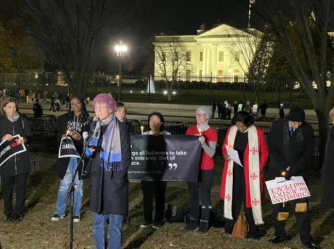 Bishop Mariann Budde, Israel-Hamas vigil, Nov. 20, 2023. Bishop stands in front of White House at night.