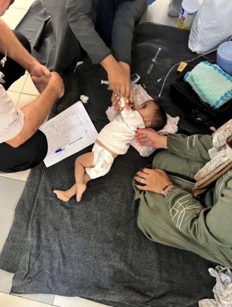 child on stretcher with doctors working