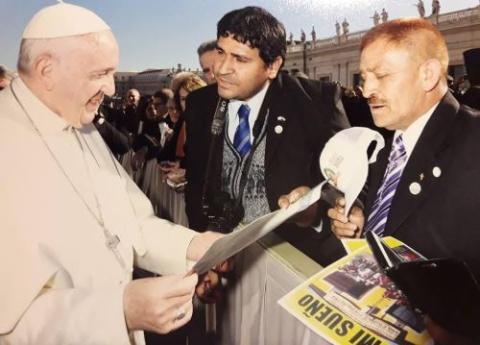 Cesar Sanabria and Juan Romero, both Villa 31 residents, talk with Pope Francis at the Vatican in 2018. Romero remembers seeing the future pope, Jorge Mario Bergoglio, in the Buenos Aires slum area in the 1990s. (Courtesy of Juan Romero) Cesar Sanabria and Juan Romero, both Villa 31 residents, talk with Pope Francis at the Vatican in 2018. Romero remembers seeing the future pope, Jorge Mario Bergoglio, in the Buenos Aires slum area in the 1990s. (Courtesy of Juan Romero)
