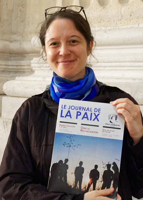 Bérengère Savélieff, peace education officer for Pax Christi France, holds a copy of the organization’s peace journal in September 2024. (Courtesy of Pax Christi France)