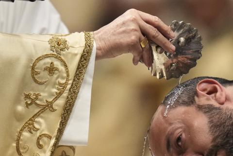 Giovanni Battista Re baptizes a man as he leads the Easter vigil inside St. Peter's Basilica Giovanni Battista Re baptizes a man as he leads the Easter vigil inside St. Peter's Basilica at the Vatican, Saturday, April 19, 2025. (AP Photo/Alessandra Tarantino)