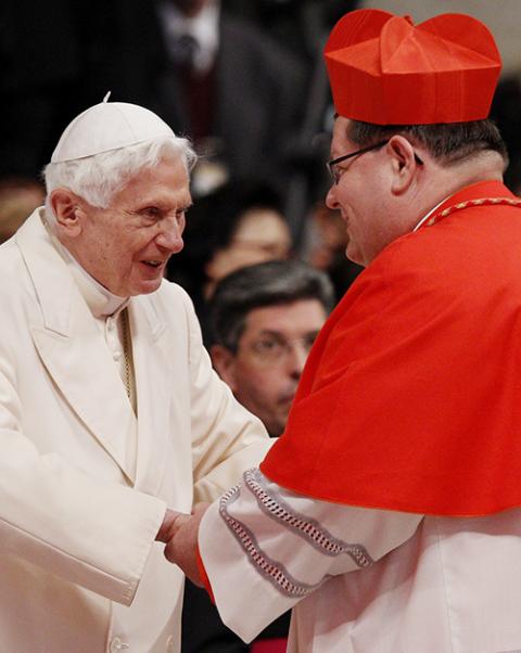 Retired Pope Benedict XVI greets new Cardinal Gérald Lacroix of Quebec during a consistory at which Pope Francis created 19 new cardinals in St. Peter's Basilica at the Vatican Feb. 22, 2014. (CNS/Paul Haring)