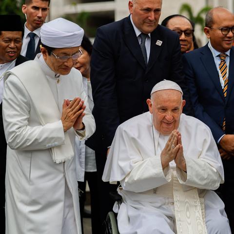 Pope Francis and Nasaruddin Umar, grand imam of the Istiqlal, fold their hands in a gesture of gratitude at the conclusion of an interreligious meeting at the Istiqlal Mosque in Jakarta, Indonesia, on Sept. 5, 2024. (CNS/Lola Gomez)