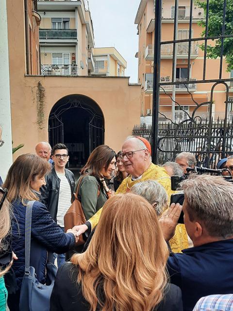 Cardinal Timothy Dolan of New York speaks with parishioners after he celebrated Mass at Our Lady of Guadalupe Church, his titular church in Rome, May 4, 2025. (CNS/Carol Glatz)