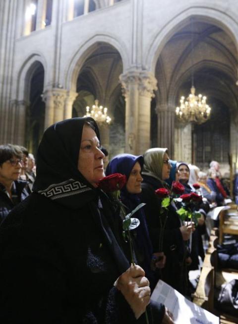 A file photo shows worshippers praying during Mass at Notre Dame Cathedral in Paris. (CNS/Paul Haring)