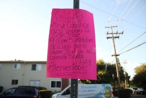 Handwritten signs invite residents to monthly pop-up Masses, known as Misas del Barrio, which pair liturgy with community listening sessions in a central Silicon Valley neighborhood. (Marissa Nichols)