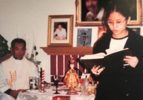 Aimee Torres, pictured in 1999, reads during a Mass celebrated by Fr. Honesto Bayranta Bismonte in her family's home. In 2002, Bismonte was arrested and charged with sexually molesting two young girls, including Torres. (Courtesy of Aimee Torres)
