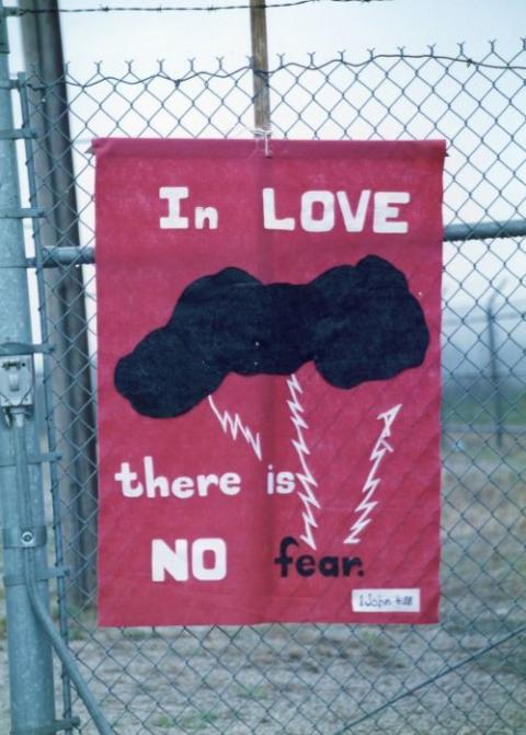 A banner hung by Fr. Carl Kabat of the Missionary Oblates of Mary Immaculate and fellow protester Carol Carson is seen on a fence surrounding a nuclear missile silo in Missouri during a Good Friday protest April 17, 1992. (NCR file photo)