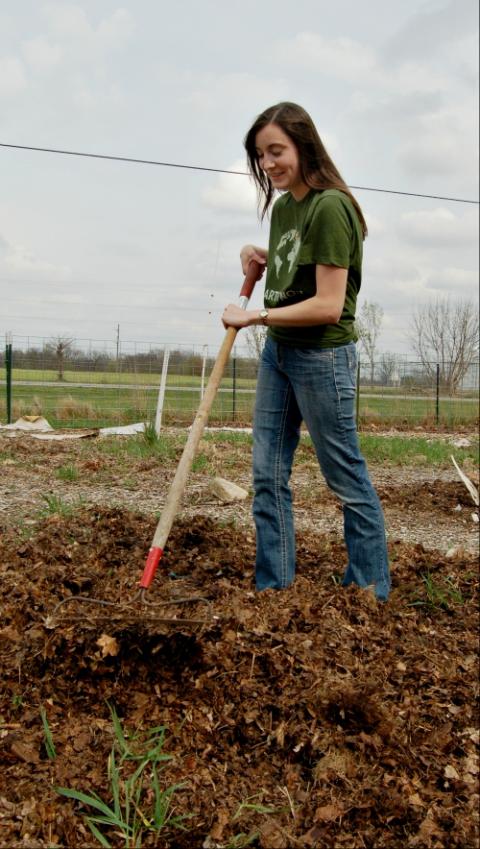 Holly Sammons, a volunteer with the Adrian Dominican Sisters, prepares a garden plot for spring planting in April 2017 in Michigan. (CNS/Global Sisters Report/Provided photo)