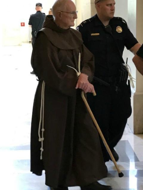 U.S. Capitol Police arrest Franciscan Fr. Joseph Nangle at the rotunda of the Russell Senate building in Washington, D.C. in July 2019. (Courtesy of Fr. Joseph Nangle) U.S. Capitol Police arrest Franciscan Fr. Joseph Nangle at the rotunda of the Russell Senate building in Washington, D.C. in July 2019. (Courtesy of Fr. Joseph Nangle)