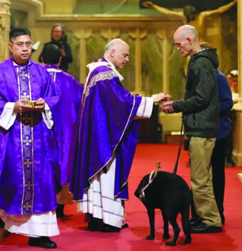 Archbishop Salvatore Cordileone distributes Communion at the Nov. 8 Mass of the Dead for Our Homeless Brethren at San Francisco's St. Patrick Church. (Archdiocese of San Francisco Office of Human Life and Dignity/Debra Greenblat)