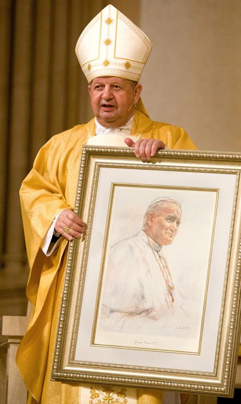 Polish Cardinal Stanislaw Dziwisz presents a framed portrait of Pope John Paul II to members of St. Patrick Parish in Miami Beach Feb. 3, 2005. (CNS/Tom Tracy)