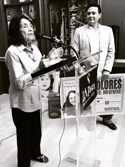 David Damian Figueroa watches as Dolores Huerta addresses the crowd at the pre-reception for the premiere of the documentary "Dolores." (Courtesy of David Damian Figueroa)
