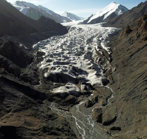 Water flows from a glacier in China. The world will be watching for bipartisan support of U.S. climate commitments, experts say. (CNS photo/Carlos Garcia Rawlins, Reuters)