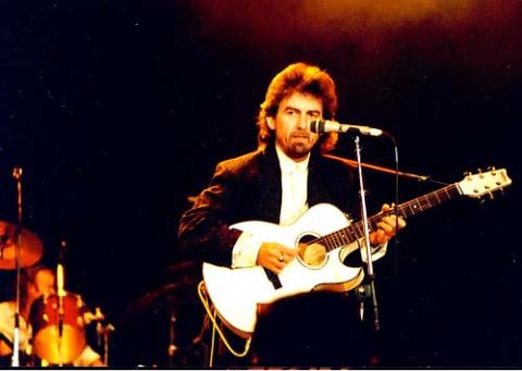 George Harrison plays "Here Comes the Sun" at Wembley Arena during a Prince's Trust concert June 5, 1987. (Flickr/Badgreeb Pictures)