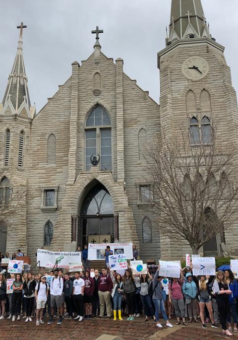 Hundreds of Creighton University students demonstrate outside St. John's Church on the Omaha, Nebraska, campus in April 2019, pressing the Jesuit school to take increased action on climate change, including divesting its endowment from fossil fuels. Hundreds of Creighton University students demonstrate outside St. John's Church on the Omaha, Nebraska, campus in April 2019, pressing the Jesuit school to take increased action on climate change, including divesting its endowment from fossil fuels.