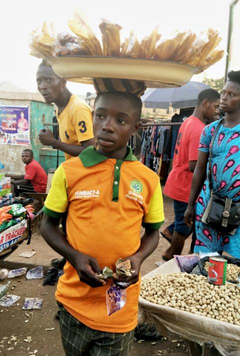 Every day, Arinze Olu, 12, comes to one of the popular markets in Enugu State, South East Nigeria, to hawk fried plantains for his mother after school. (Patrick Egwu) Every day, Arinze Olu, 12, comes to one of the popular markets in Enugu State, South East Nigeria, to hawk fried plantains for his mother after school. (Patrick Egwu)