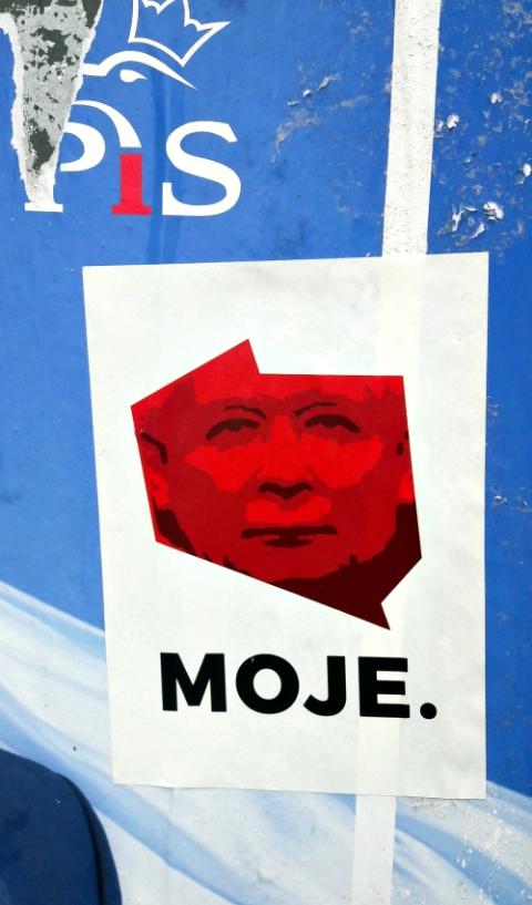 A picture of Jaroslaw Kaczynski and the logo of his Law and Justice party are seen on a wall during local elections in Poland Oct. 7. (Wikimedia Commons/Silar)