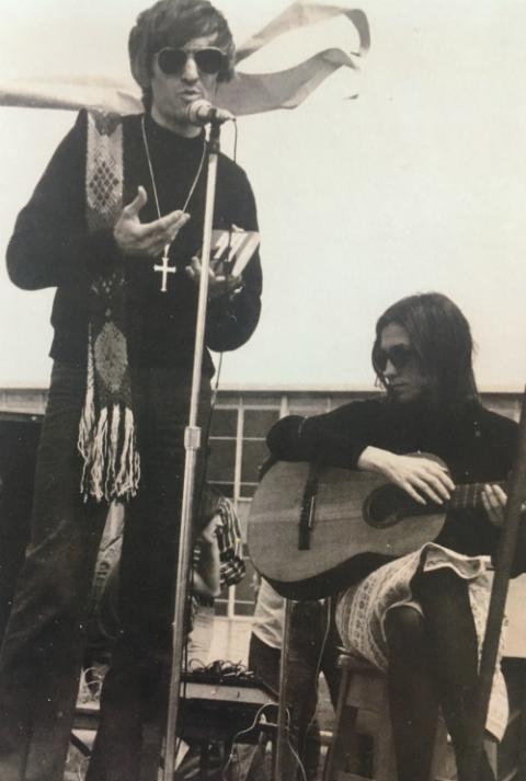 Fr. John Giuliani and Sr. Kathleen Deignan appear on stage during an outdoor liturgical service at Sacred Heart University for the first Earth Day on April 22, 1970. (Courtesy of Kathleen Deignan) Fr. John Giuliani and Sr. Kathleen Deignan appear on stage during an outdoor liturgical service at Sacred Heart University for the first Earth Day on April 22, 1970. (Courtesy of Kathleen Deignan)