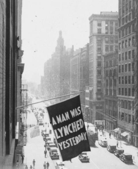 A flag reporting a lynching is flown from the window of the NAACP headquarters on Fifth Avenue in New York City. (Library of Congress/Courtesy of NAACP)