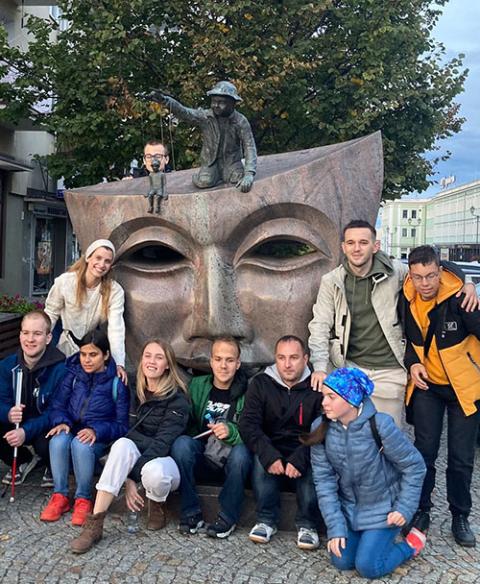 New social theater facilitators Marina Zharkovska, Mykola Panaciuk and Polina Frulova pose with blind and visually impaired refugees from Ukraine at the close of their workshop in Bialystock, Poland (Courtesy of Mykola Panaciuk)