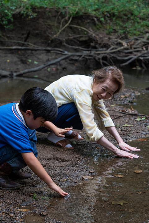 Alan S. Kim as David and Yuh-Jung Youn as Soonja in "Minari" (Courtesy of A24/Melissa Lukenbaugh)