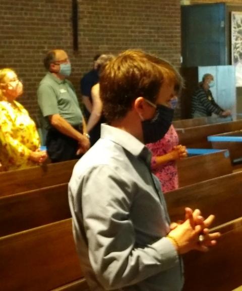 A young worshipper at St. John Fisher on a recent Sunday. The church serves as the Newman Center for students from nearby Oakland University. (Matt Jachman)