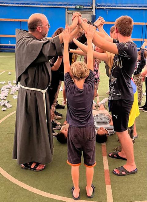 Conventual Franciscan Fr. Michael Lasky undertakes an acting exercise with Ukrainian refugees. (Stefano Luca)