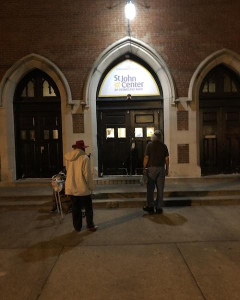 People wait in the early morning in front of St. John Center in Louisville, Kentucky. The shelter is one of three programs operated by the agency, which includes street outreach, social services program, and a supportive housing program that works with 92