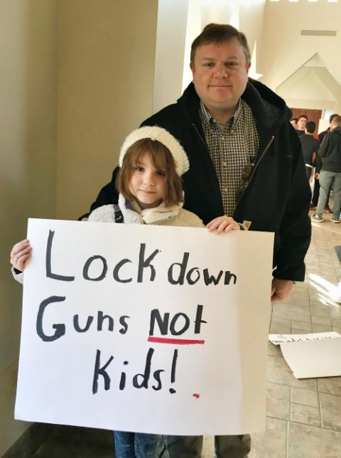 The principal of St. Joseph Academy, Jeff Sutliff, and his daughter prepare to join the March for Our Lives in Cleveland March 24. (Christine Schenk)