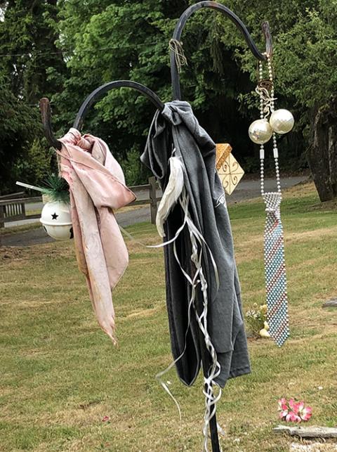 Ted George mementos Mementos honor a grave at the Suquamish cemetery, not far from the place where Ted George is buried. (The Cedar Tree Institute)