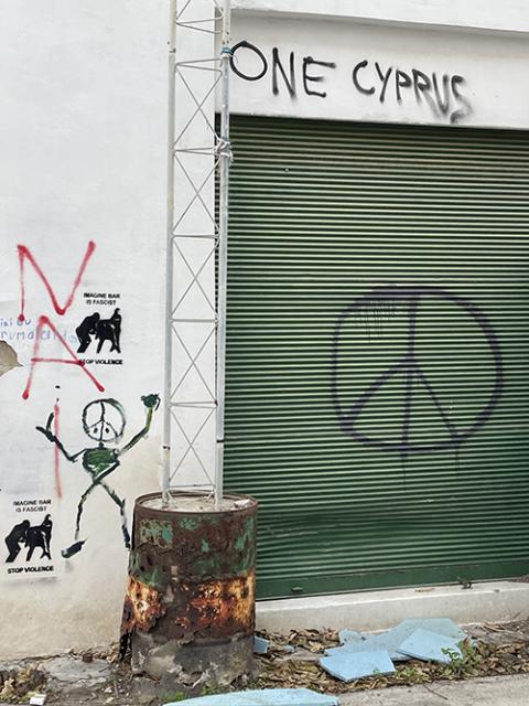 Calls for "One Cyprus" are written in graffiti in the U.N. controlled buffer zone in Nicosia. (NCR/Christopher White)