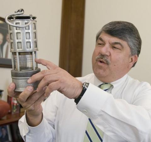 Richard L. Trumka displays an old miner's safety lamp in his office at AFL-CIO headquarters in Washington in 2010. (CNS photo/Nancy Wiechec)