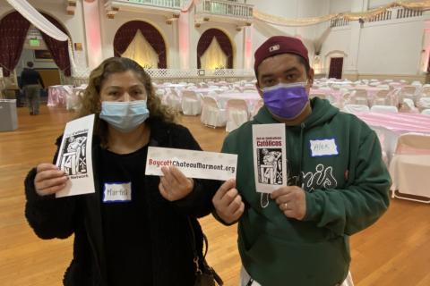 Former Chateau Marmont employees, Martha Moran and Alex Roldan, hold up protest materials inside Blessed Sacrament Church in Hollywood, California, on Dec. 4, 2021. (Photo courtesy of Maria Hernandez/United Here Local 11)
