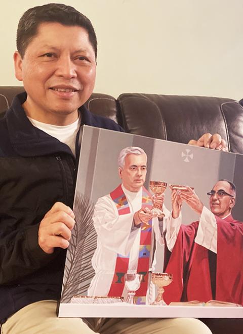 José Ortiz, 53, holds an image of the Rev. Rutilio Grande and St. Oscar Romero March 8 at his Los Angeles home while sitting for a portrait. (RNS photo/Alejandra Molina)