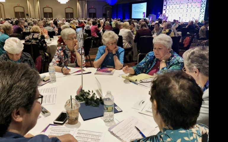Sisters share their thoughts with the other sisters at their tables after a keynote speaker at the 2018 Leadership Conference of Women Religious annual assembly, held Aug. 7-10 in St. Louis. (GSR file photo)