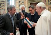 Pope Francis accepts a violin that prisoners in Milan made from the wood of a shipwrecked refugee boat during an audience with members of the Casa dello Spirito e delle Arti Foundation at the Vatican Feb. 4. (CNS/Vatican Media)