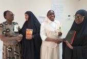 A Catholic woman and nun exchange holy books with Muslim women leaders Dec. 13, 2019, in Garissa, Kenya. (CNS/Courtesy of Fr. Nicholas Mutua)