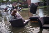 A man moves his flood-damaged sofas in Houston in the wake of Hurricane Harvey in 2017. Scientists say restoring and preserving wetlands could prevent millions of dollars' worth of damage from severe storms. (CNS photo/Adrees Latif, Reuters)