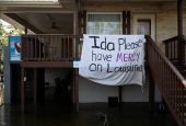 A blanket hangs outside a house Jean Lafitte, La., Sept. 2, 2021, following Hurricane Ida's landfall. The blanket reads "Ida please have mercy on Louisiana." (CNS photo/Marco Bello, Reuters)