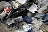 A Haitian passport is seen in a pile of trash Sept. 21, 2021, in Del Rio, Texas, near the International Bridge between Mexico and the United States. (CNS photo/Marco Bello, Reuters)