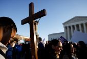 A pro-life activist holding a crucifix joins a protest outside the U.S. Supreme Court building Dec. 1, 2021, in Washington. (CNS/Reuters/Jonathan Ernst)