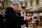 British Prime Minister Boris Johnson attends a prayer service with Bishop Kenneth Nowakowski, head of the Ukrainian Catholic Diocese of the Holy Family in London, at the Ukrainian Catholic cathedral in London Feb. 27, 2022. (CNS photo/Jamie Lorriman, Pool