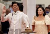 Ferdinand "Bongbong" Marcos Jr., the son and namesake of the late dictator Ferdinand Marcos, takes the oath of office beside his wife, Louise Araneta-Marcos, during the presidential inauguration ceremony at the National Museum in Manila, Philippines.