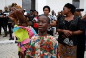 A woman and child cry following a funeral Mass in the parish hall of St. Francis Xavier Church in Owo, Nigeria, June 17. The Mass was for some of the 40 victims killed in a June 5 attack by gunmen during Mass at the church. (CNS/Reuters/Temilade Adelaja)
