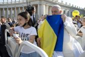 Pope Francis holds a Ukrainian flag as he greets the crowd before Mass in St. Peter's Square during the World Meeting of Families at the Vatican in this June 25, 2022, file photo.
