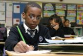 Fourth-grader Richard Blount works on a social studies assignment at Our Lady of Lourdes School in Massapequa Park, N.Y., Jan. 14, 2004. At the time, more than 2.5 million students were enrolled in 8,000 Catholic schools in the U.S.