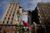 A flower is pictured in front of the destroyed regional administration building following shelling by Russian troops in Mykolaiv, Ukraine, June 8. (CNS/Reuters/Edgar Su)